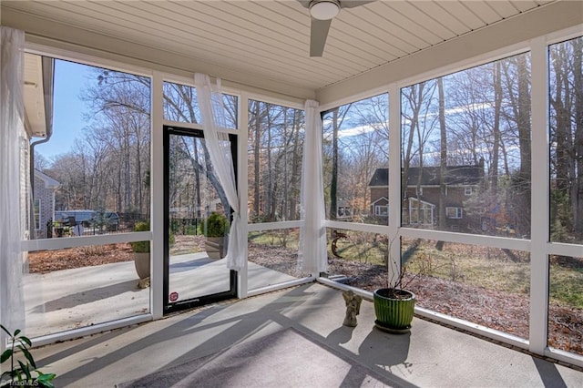 unfurnished sunroom with ceiling fan