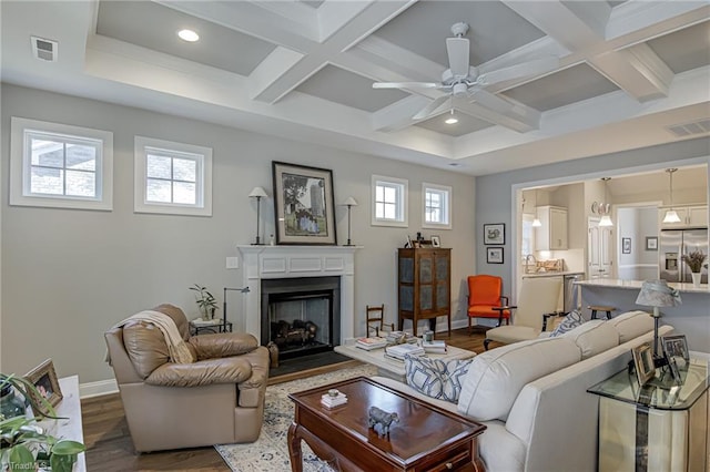 living room featuring coffered ceiling, beam ceiling, wood-type flooring, and ceiling fan