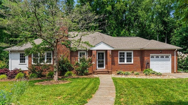 407 Pinedale Dr, Reidsville, NC 27320 - view of front of house featuring an attached garage, a chimney, a front lawn, and brick siding