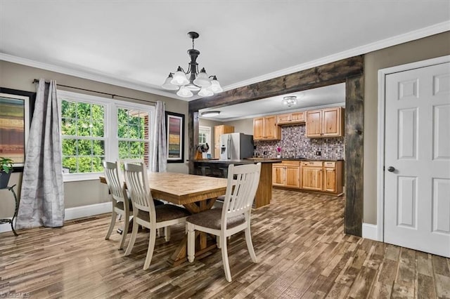 407 Pinedale Dr, Reidsville, NC 27320 - dining area with a chandelier, ornamental molding, and wood finished floors