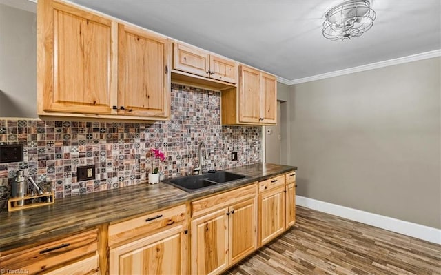 407 Pinedale Dr, Reidsville, NC 27320 - kitchen featuring dark countertops, decorative backsplash, crown molding, light brown cabinetry, and wood finished floors