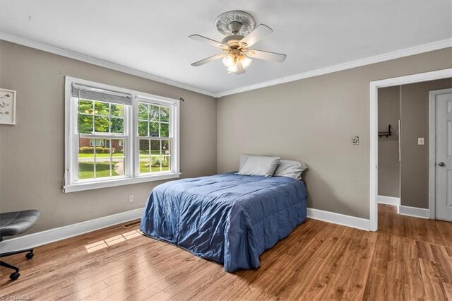 407 Pinedale Dr, Reidsville, NC 27320 - bedroom with crown molding, wood finished floors, and ceiling fan
