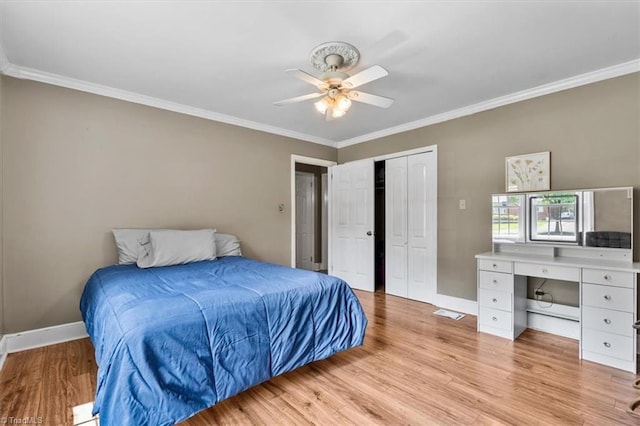 407 Pinedale Dr, Reidsville, NC 27320 - bedroom with ornamental molding, a desk, light wood finished floors, a closet, and ceiling fan