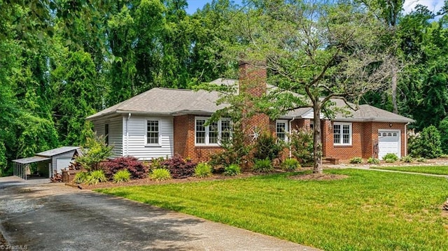 407 Pinedale Dr, Reidsville, NC 27320 - ranch-style house with a chimney, a front lawn, brick siding, and a garage