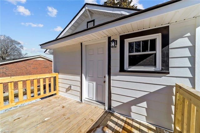 entrance to property featuring a wooden deck