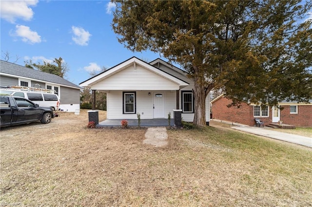 bungalow-style house with a porch and a front yard