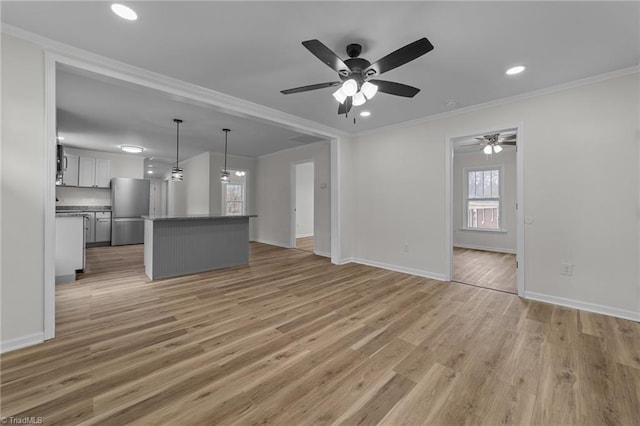 unfurnished living room with crown molding, light hardwood / wood-style floors, and ceiling fan