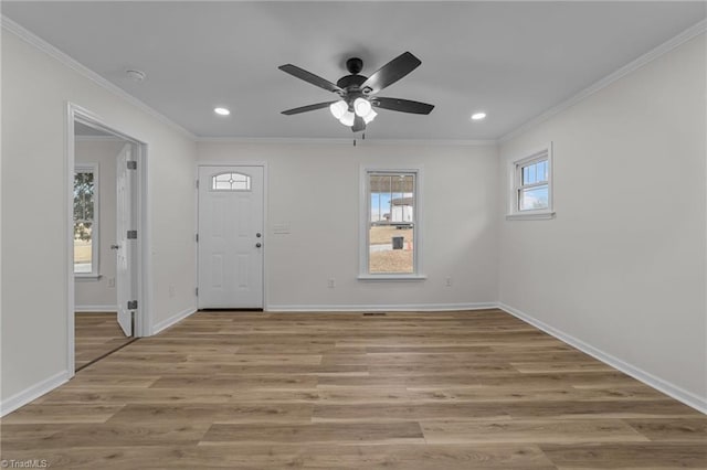 foyer entrance featuring ceiling fan, ornamental molding, and light hardwood / wood-style floors