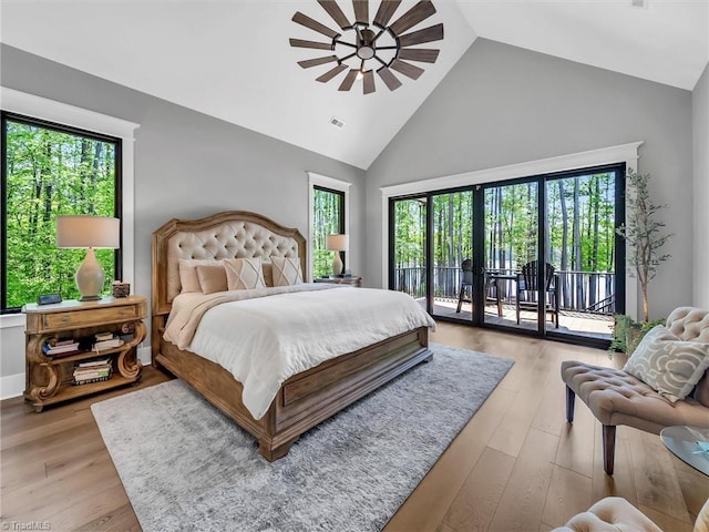 1579 Sunset Pointe Dr, Salisbury, NC 28146 - bedroom with high vaulted ceiling, access to outside, multiple windows, and light wood-style flooring
