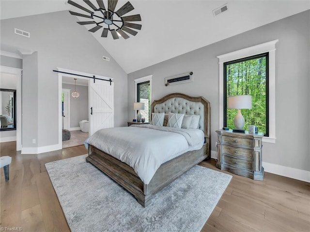 1579 Sunset Pointe Dr, Salisbury, NC 28146 - bedroom featuring multiple windows, visible vents, high vaulted ceiling, and a barn door