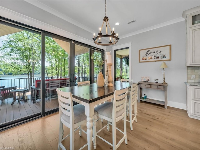 1579 Sunset Pointe Dr, Salisbury, NC 28146 - dining room with light wood-type flooring, plenty of natural light, visible vents, and a notable chandelier