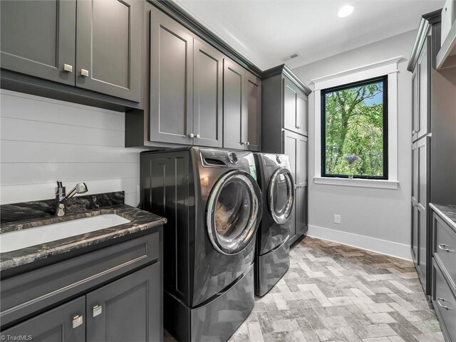 1579 Sunset Pointe Dr, Salisbury, NC 28146 - laundry area featuring a sink, brick floor, washer and dryer, cabinet space, and baseboards