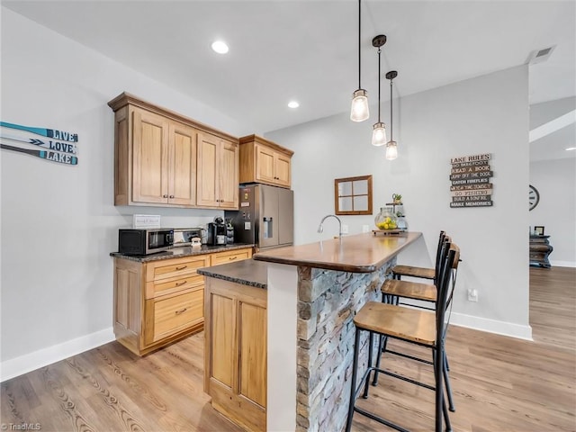 1579 Sunset Pointe Dr, Salisbury, NC 28146 - kitchen featuring stainless steel fridge, dark countertops, baseboards, and light wood-style flooring