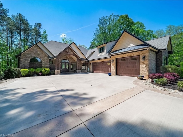 1579 Sunset Pointe Dr, Salisbury, NC 28146 - view of front of property featuring concrete driveway, an attached garage, stone siding, and french doors