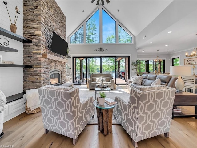 1579 Sunset Pointe Dr, Salisbury, NC 28146 - living room with a stone fireplace, a healthy amount of sunlight, and light wood-style flooring