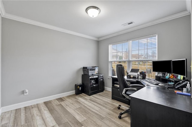 home office featuring baseboards, light wood finished floors, visible vents, and crown molding