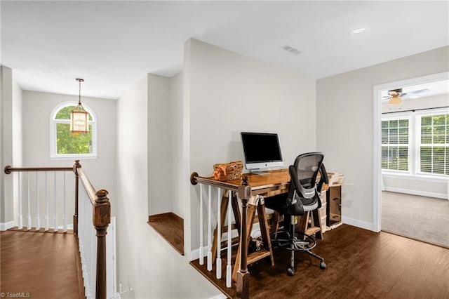 office space with wood finished floors, plenty of natural light, baseboards, and a ceiling fan