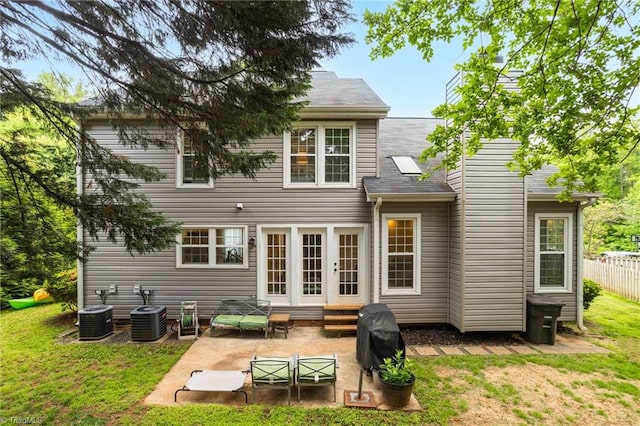 back of property featuring a patio, french doors, central AC, and roof with shingles