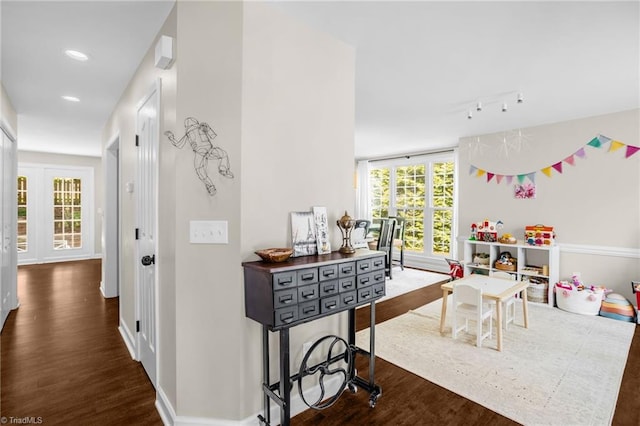 hall with dark wood-style flooring, recessed lighting, and baseboards