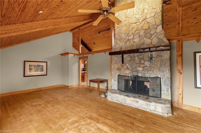unfurnished living room with a stone fireplace, wood-type flooring, wooden ceiling, ceiling fan, and beam ceiling