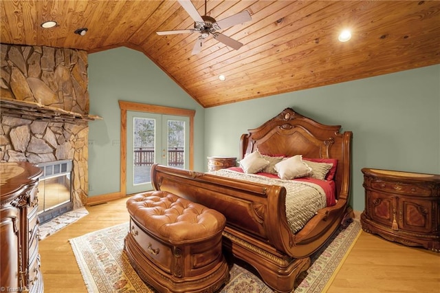 bedroom with lofted ceiling, wood ceiling, light hardwood / wood-style flooring, access to outside, and a fireplace