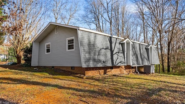 view of property exterior featuring crawl space, central AC unit, and a lawn