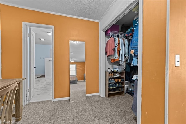 carpeted bedroom featuring a textured ceiling, a closet, and ornamental molding