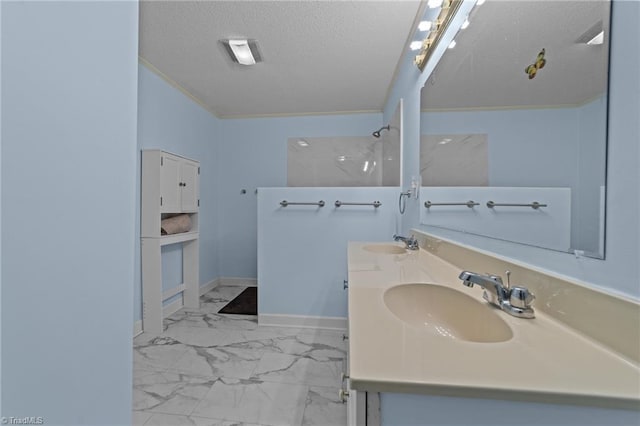 bathroom with a shower, vanity, and a textured ceiling