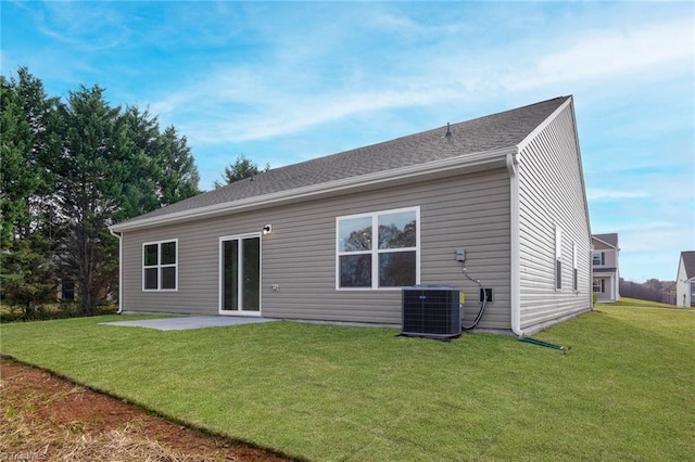 back of house with a lawn, a patio area, and central air condition unit