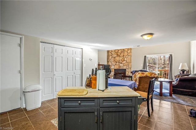 dining room with a stone fireplace