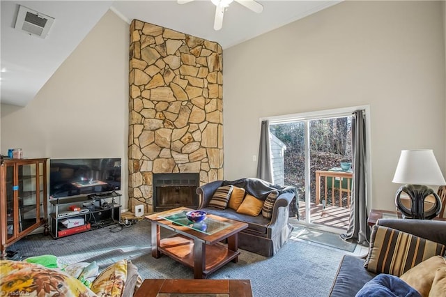 living room featuring ceiling fan, carpet flooring, a stone fireplace, and high vaulted ceiling