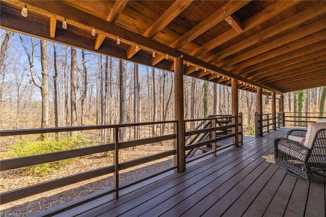 wooden deck featuring a forest view