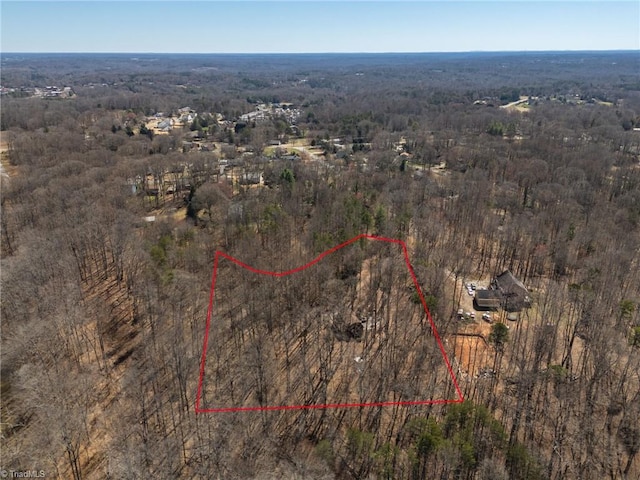 drone / aerial view featuring a forest view