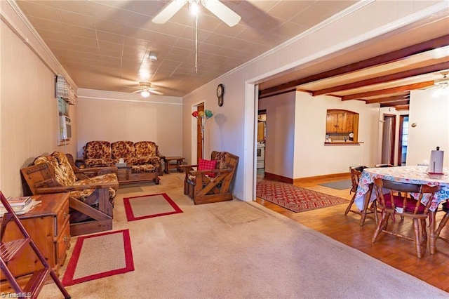 carpeted living room featuring ceiling fan, ornamental molding, and beam ceiling