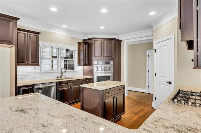 kitchen featuring light stone countertops, sink, dark hardwood / wood-style flooring, dark brown cabinets, and appliances with stainless steel finishes