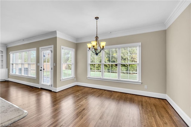 unfurnished dining area featuring a chandelier, dark hardwood / wood-style flooring, and ornamental molding