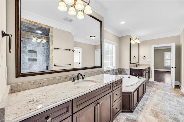 bathroom featuring plenty of natural light, ornamental molding, vanity, and a chandelier