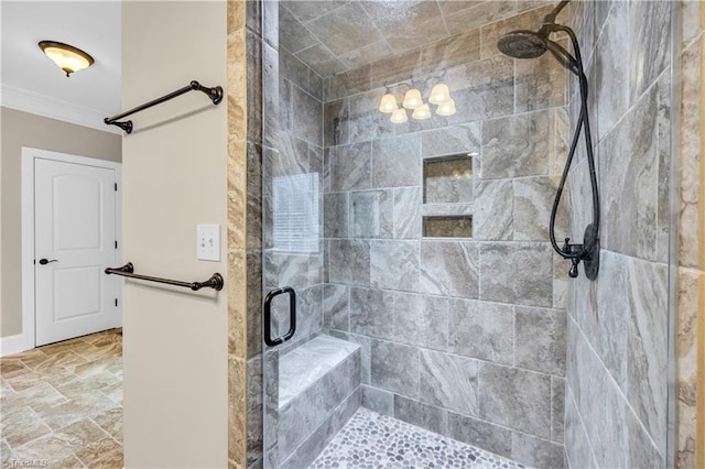 bathroom featuring a shower with shower door and ornamental molding