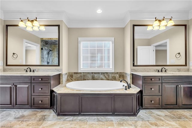 bathroom with a bathtub, vanity, and ornamental molding