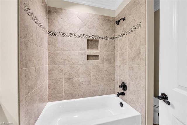 bathroom featuring tiled shower / bath combo and ornamental molding