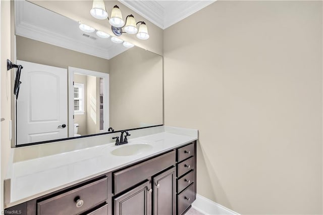 bathroom featuring toilet, vanity, an inviting chandelier, and ornamental molding