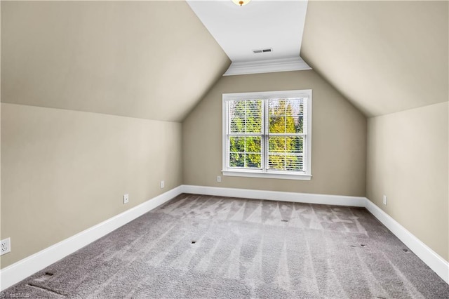 bonus room with lofted ceiling and carpet floors