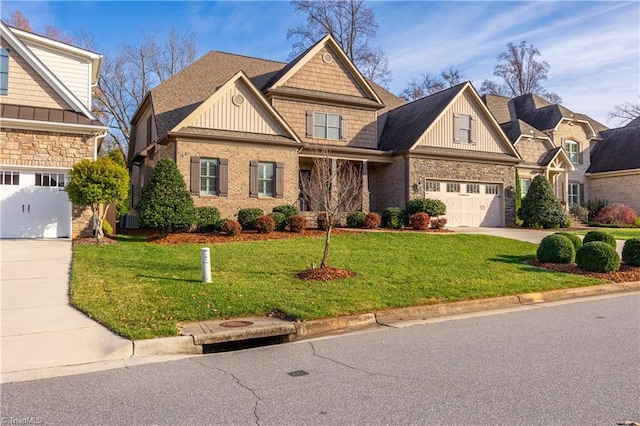 craftsman-style home with cooling unit, a garage, and a front yard