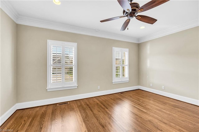 empty room featuring hardwood / wood-style flooring, ceiling fan, and ornamental molding