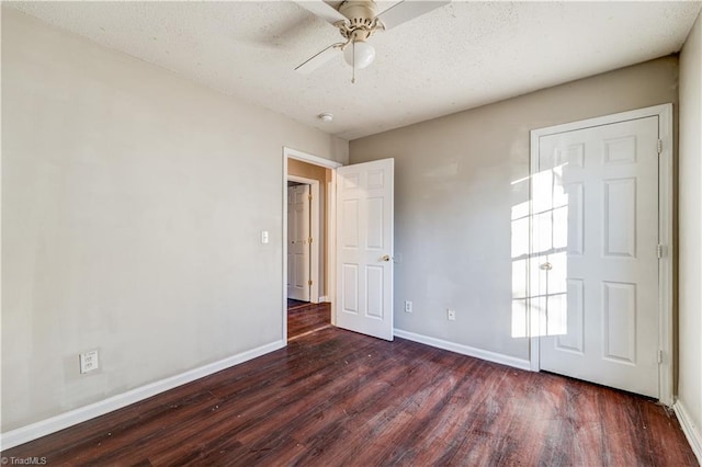 unfurnished room with ceiling fan and dark hardwood / wood-style floors