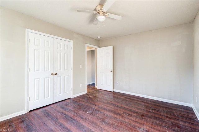 unfurnished bedroom featuring ceiling fan, dark hardwood / wood-style floors, and a closet