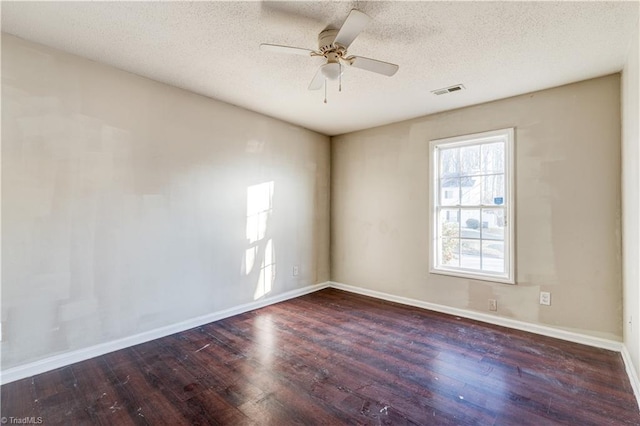 spare room featuring a textured ceiling, dark hardwood / wood-style floors, and ceiling fan