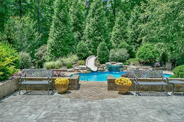 view of pool featuring a patio and a water slide