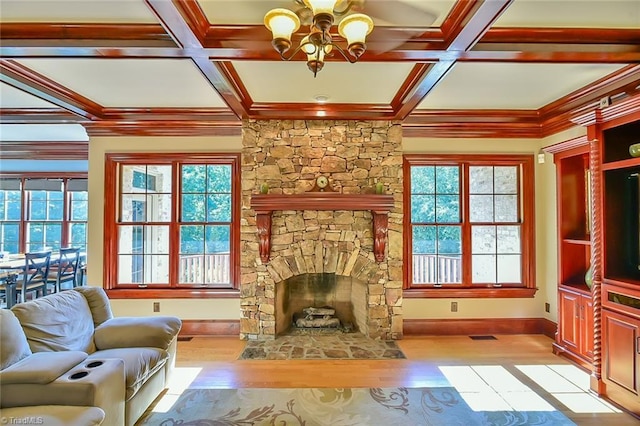 living room with a fireplace, light hardwood / wood-style flooring, coffered ceiling, a notable chandelier, and beam ceiling