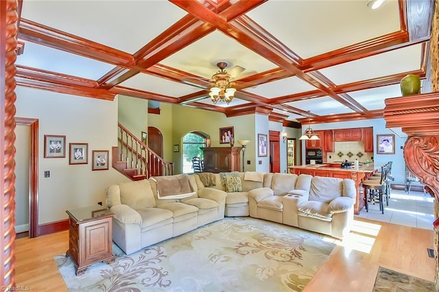 living room with ceiling fan, light hardwood / wood-style flooring, and coffered ceiling